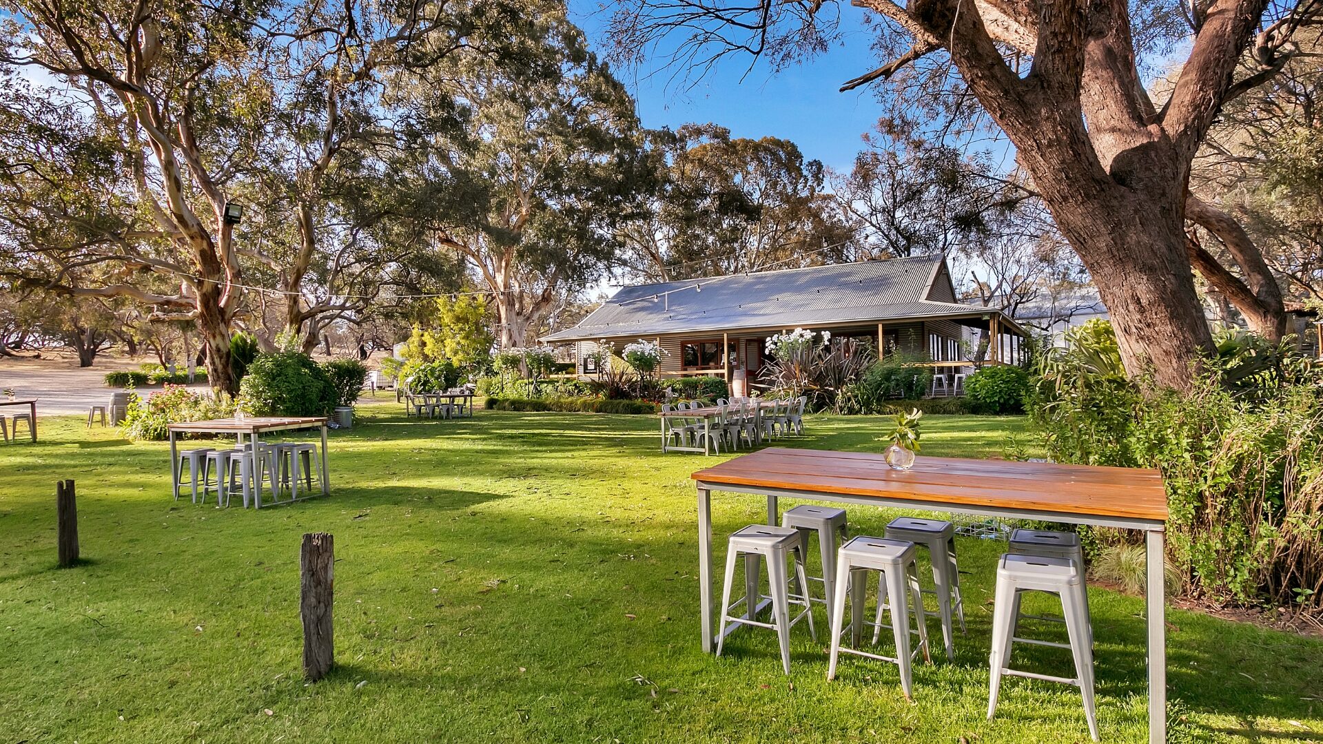 Whistler Wines cellar door - tables, chairs and lawn under the trees